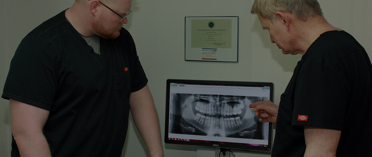 Doctors Stephen and Franklin Boyles examining dental x rays